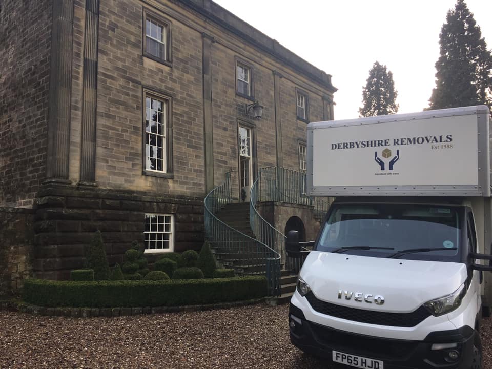 Carefully wrapped antique furniture being handled by specialists